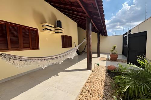 a patio of a house with a hammock on it at Casa com piscina para família em Bonito - Mato Grosso do Sul in Bonito