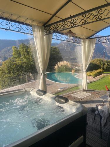 a hot tub in a patio with a view at Casa Ronco Frati, piscina vista lago in Pisogne