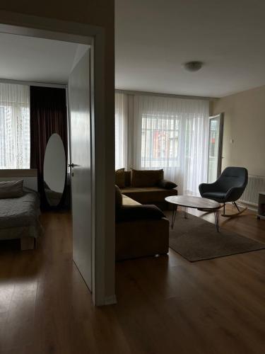 a living room with a couch and a table at Apartment in Prishtina, Kosovo in Pristina