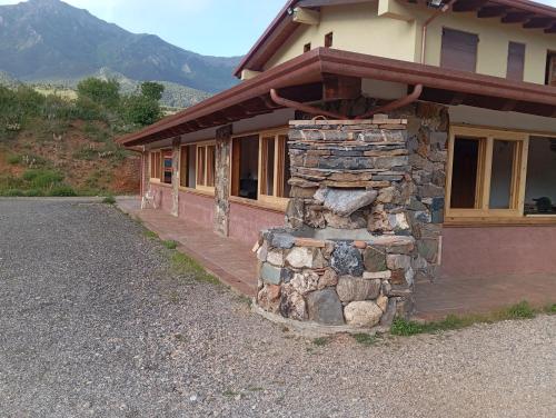 a building with a stone pillar in front of it at Agriturismo Conca del Re in Castrovillari