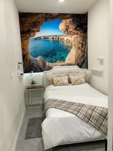 a bedroom with a cave wall mural at Rooms SWEET Rooms in Davenport