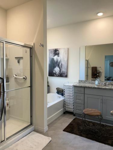 a bathroom with a shower and a sink and a tub at Rooms SWEET Rooms in Davenport