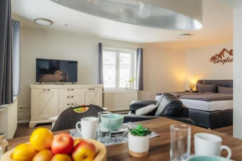 a living room with a table with fruit on it at Fünf Harzer Berge Oderberg in Sankt Andreasberg