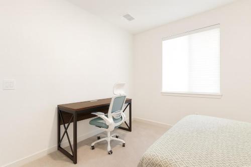 a bedroom with a desk and a chair next to a bed at Modern Private Room with Private Bath in Manteca