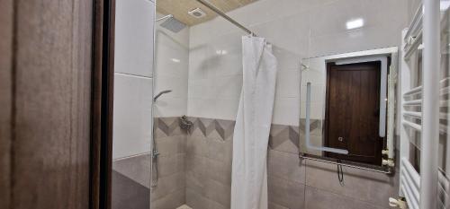 a bathroom with a shower with a shower curtain at Zeytoun Guest House in Yerevan