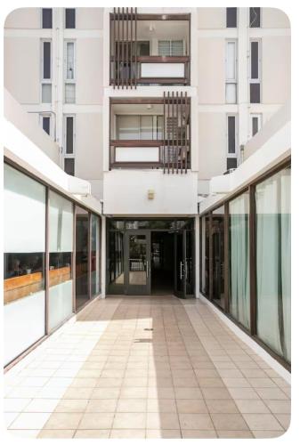 an empty hallway in a building with glass doors at ÁMARE | Cozy Beach Studio | Generator | Condado in San Juan