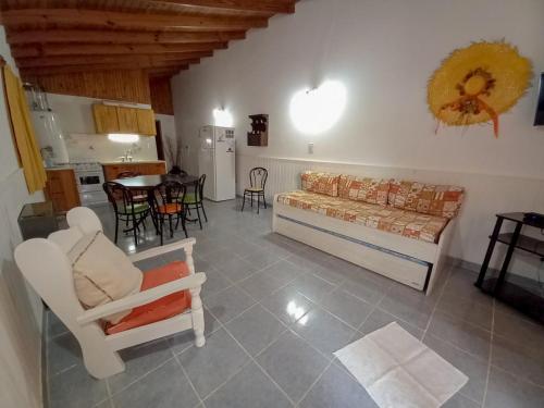 a living room with a couch and chairs and a table at Complejo Antilhue in Las Grutas