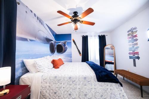 a bedroom with a plane painted on the wall at Nomad Hub,Fast Wi-Fi, King Comfort & Pool Vibes in Gainesville