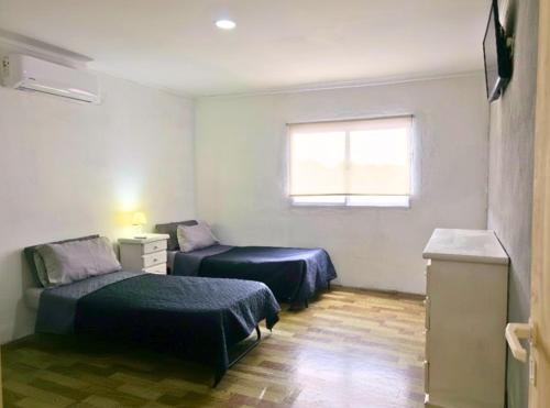 Ένα ή περισσότερα κρεβάτια σε δωμάτιο στο Casa con Pileta, Parrilla y Acceso con Rampa