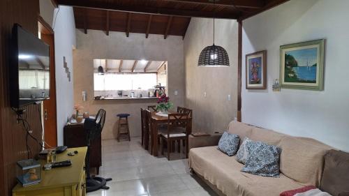 a living room with a couch and a table at Casa 05 - Grande Família in Angra dos Reis