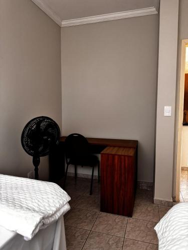 a bedroom with a desk and a chair and a bed at Condominio Delville 2 quartos in Porto Velho