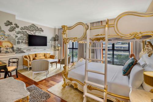 a bedroom with a bed and a living room at The Serangoon House Little India, Singapore, a Tribute Portfolio Hotel in Singapore