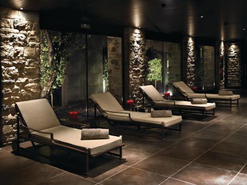 a group of lounge chairs sitting in a lobby at Hotel Castillo de Gorraiz&Spa in Gorraiz