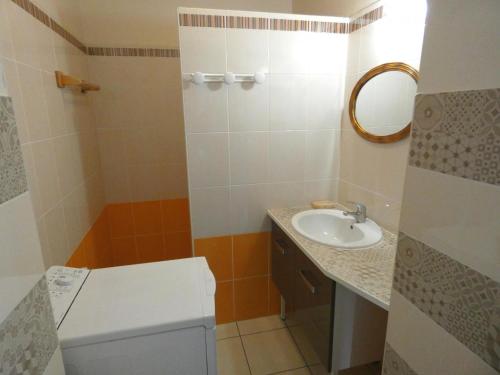 a small bathroom with a toilet and a sink at A lines in Montsoué