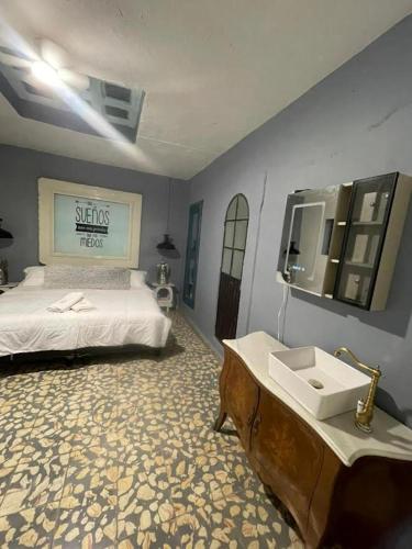 a bedroom with a bed with a sink and a mirror at apartamento Ileana in Bandita