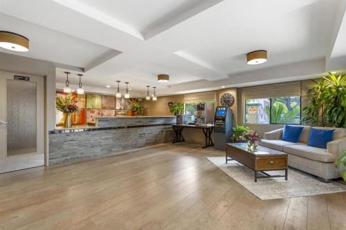 a living room with a couch and a table at Best Western Plus Anaheim Inn in Anaheim