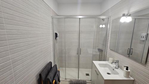 a bathroom with a shower and a sink and a mirror at Casa Daniela in Tacoronte