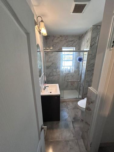 a bathroom with a shower and a sink and a toilet at Baby Hotel By BYD in Windsor