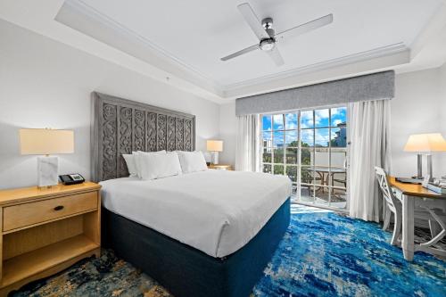 a bedroom with a bed and a desk and a window at Bellasera Resort in Naples
