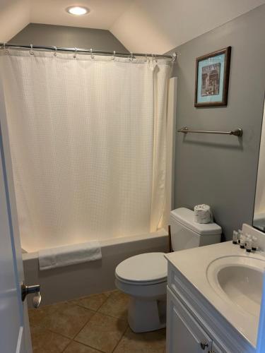 a bathroom with a white toilet and a sink at Sutton Room at The Inn, Occano Arnold Palmer Golf 