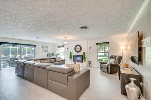 a living room with couches and a fireplace at Spacious Citrus Hills Home with Pool and Game Room! in Hernando