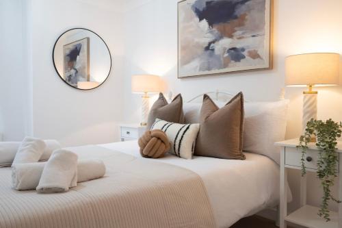 a bedroom with a white bed with a teddy bear on it at Charming 3BR Cottage Sleeps 8 - 15 Mins to Centre in Wickhambreaux