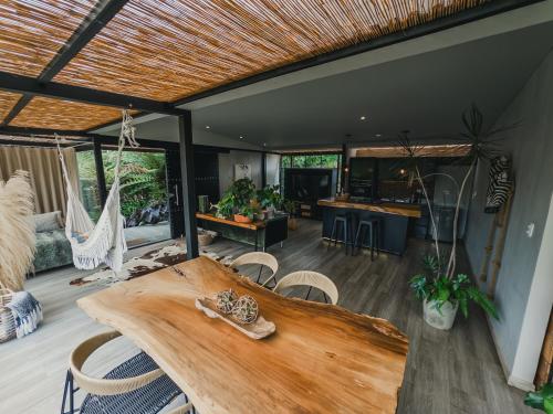 a living room with a wooden table and chairs at Element Quindío in Boquía