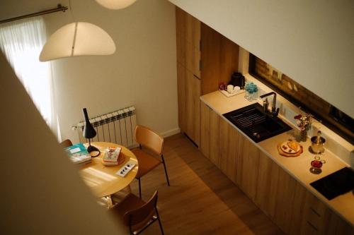 a kitchen with a counter and a table and chairs at Artifact Apart Hotel in Tbilisi City