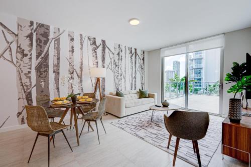 a living room with a table and chairs and a couch at 3900-719JC DESIGN DISTRICT, CONDO 1 BEDROOM /1 BATHROOM & BAYVIE in Miami