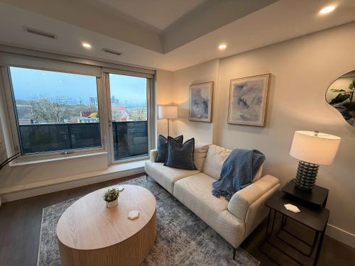 a living room with a couch and a large window at Bright 1 BR with waterview and 6 appliances in Halifax