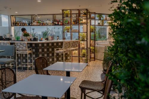 a restaurant with tables and chairs and a bar at Hotel Límade in Lima