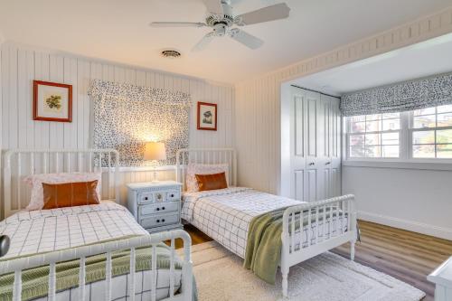 a bedroom with two beds and a window at Scenic Waterfront Home with Dock on Lake Winola! in Factoryville