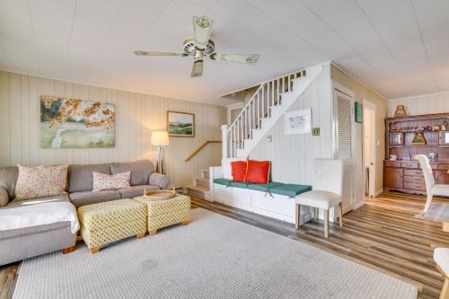 a living room with a couch and a staircase at All-Season Getaway on Lake Winola Dock and Sunroom! in Factoryville