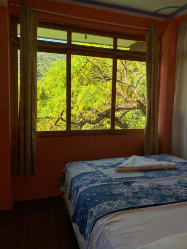 Postel nebo postele na pokoji v ubytování Hostal Xeabaj La Cascada