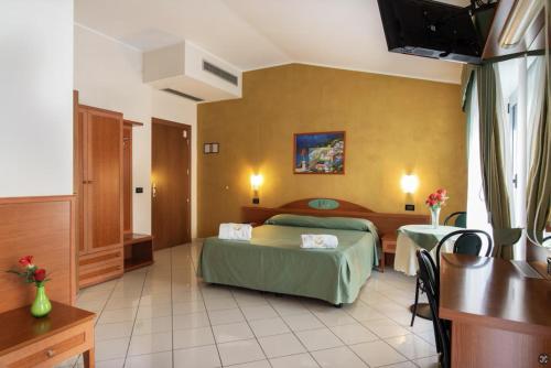 Postel nebo postele na pokoji v ubytování HD Hotel