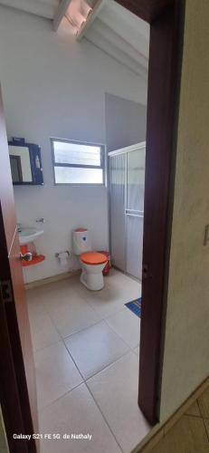 a bathroom with a toilet and a window at Finca El Paraíso in Villeta