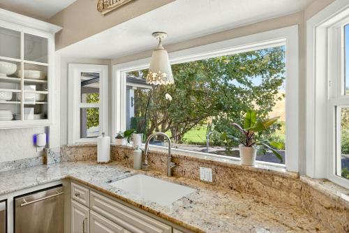 a kitchen with a sink and a large window at Meadowsweet Farm- Sleeps 18, Outdoor Kitchen in Talent