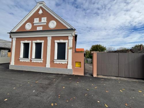 a small house with a fence in a parking lot at Hostel 164 in Beograd