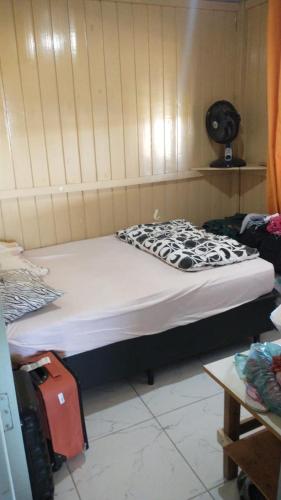 a bed in a room with at Casa de Veraneio in Passo De Torres