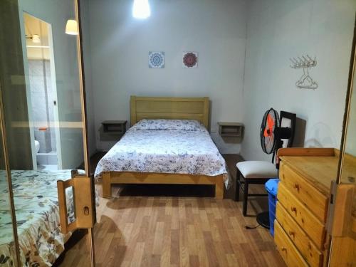 a bedroom with a bed and a mirror at Casa grande en perfecta ubicación cerca al mar in La Punta