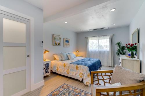 a bedroom with a bed and a chair and a window at Boat Dock and Patio Canal-Front St James City Home! in Saint James City