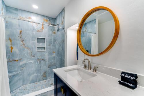 a bathroom with a sink and a mirror at Boat Dock and Patio Canal-Front St James City Home! in Saint James City