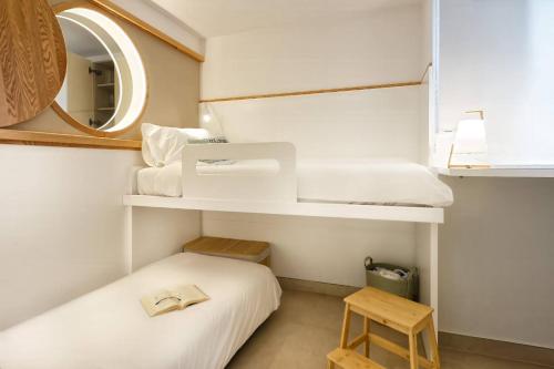 サンアグスティンにあるAmapola Moon - Calidad y disfrute en primera linea de playaのベッドと鏡のある小さな部屋