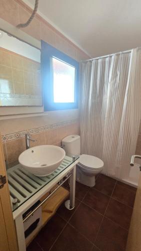 a bathroom with a sink and a toilet at The Haven of Happiness in Fátaga