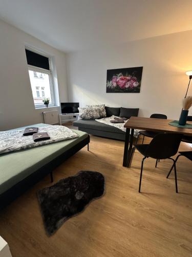 a room with a bed and a table and a couch at Modern Living Leipzig - Wohnung in Lindenau in Niederdorla