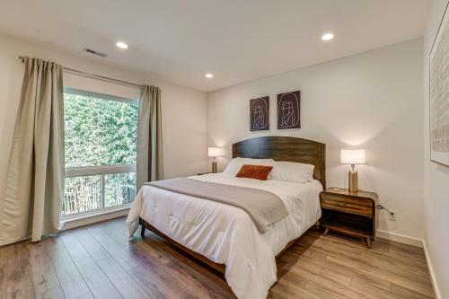 a bedroom with a large bed and a large window at 4 Mi to Dtwn Greenville Group-Ready Home with Yard in Piedmont Park