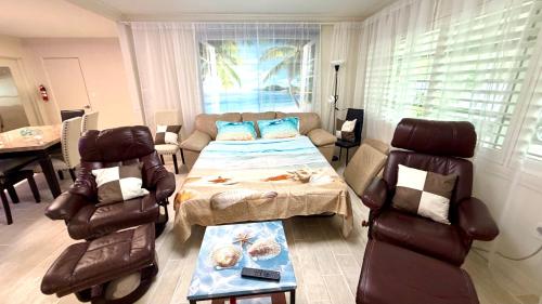 a living room with a couch and a table and chairs at Escape near to Siesta Key with Hot Tub, BBQ, and Fire pit in Sarasota