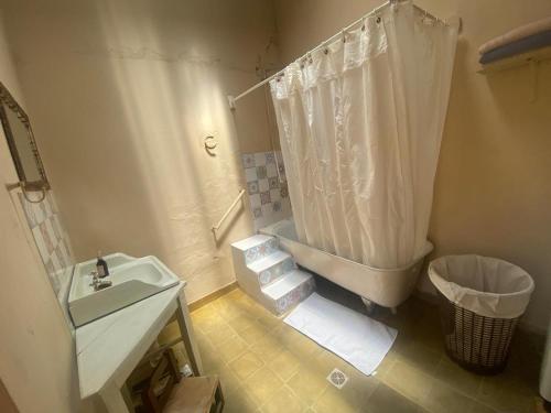 a bathroom with a sink and a shower and a toilet at Refugio Caro Cox in Tilcara