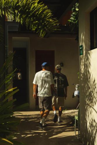 two men are walking down a sidewalk at Hostik Hostal in Mérida
