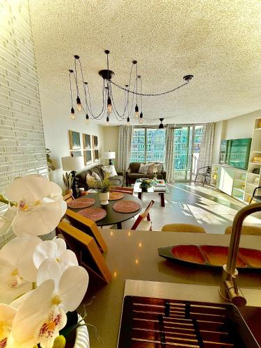 a living room with a chandelier and a living room at Stylish Designed 1BR Coral Beach by Stay Here PR in San Juan